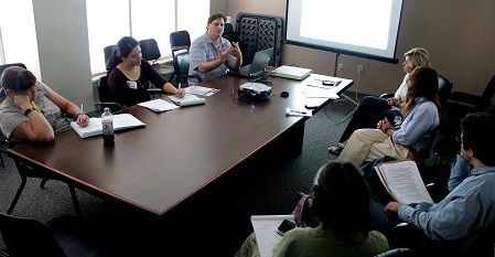 people working around conference table